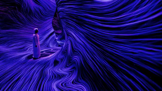 A visitor standing among flowing violet lines of light inside teamLab Phenomena Abu Dhabi